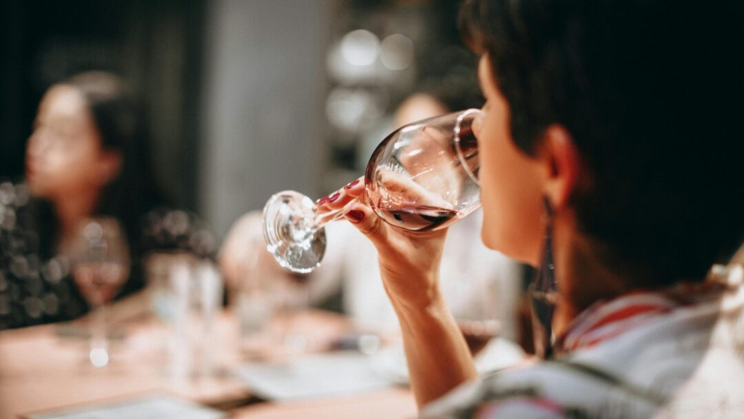 pexels-photo-696219-696219 A group of adults enjoying wine together indoors in a warm social setting.